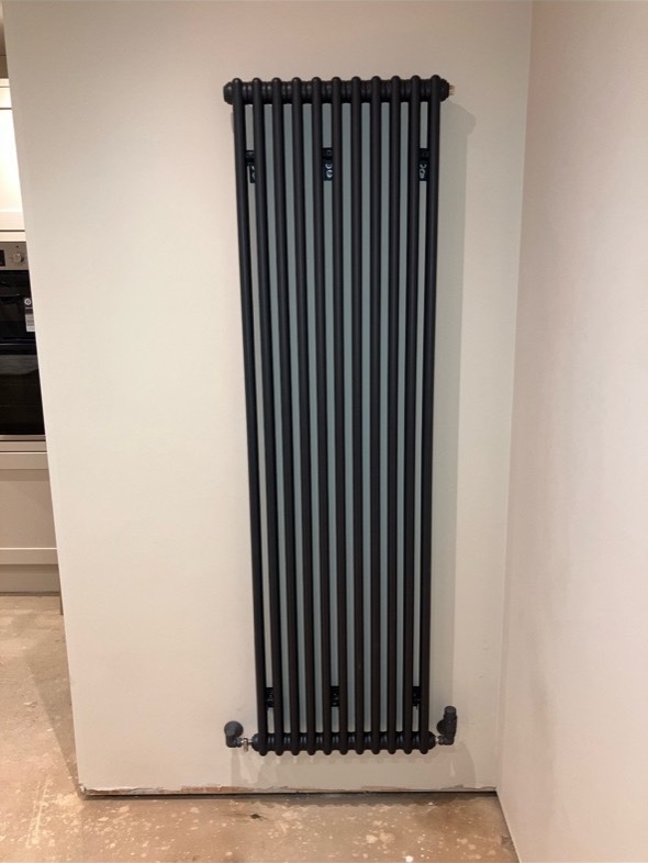 Black vertical feature radiator installation