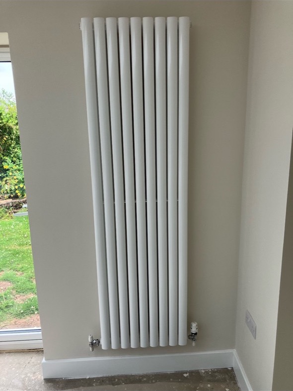 White vertical feature radiator installation
